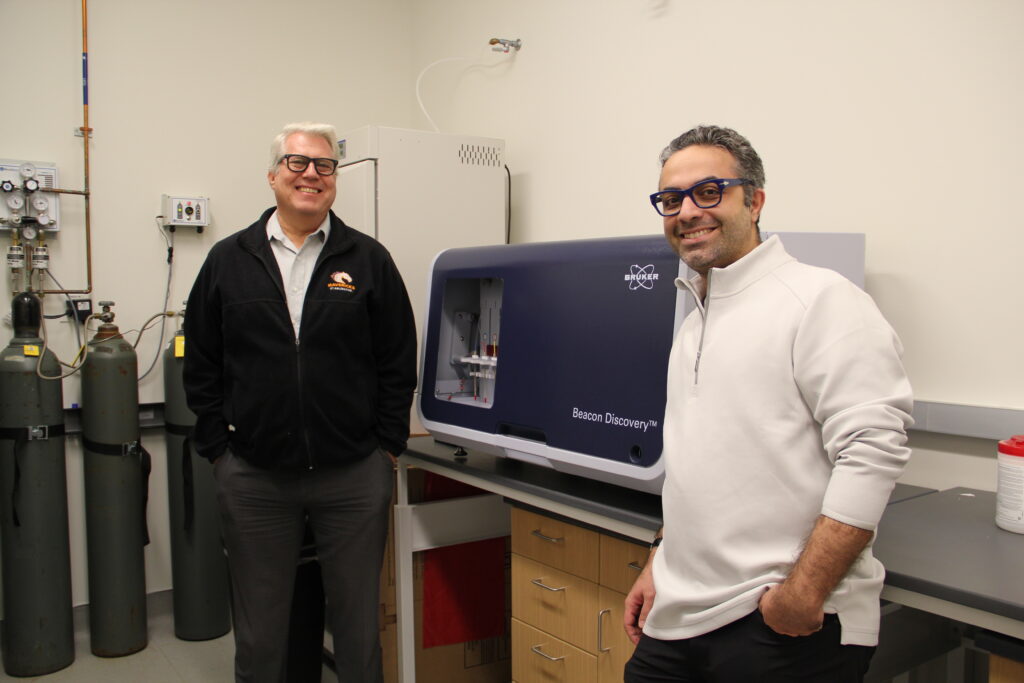 Dr. Jon Wiedanz (left) and Dr. Soroush Ghaffari (right) from the University of Texas at Arlington’s Institute of Biomanufacturing and Precision Medicine (IMPRINT) with their newly arrived Beacon Discovery instrument